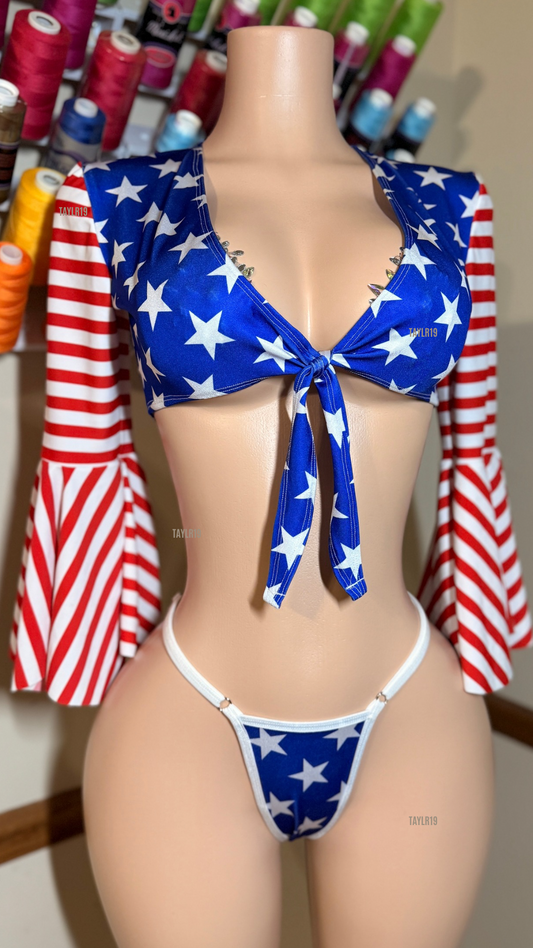 Women’s patriotic slingshot set featuring a tie-front crop top with dramatic bell sleeves and an adjustable slingshot bottom. Handmade exotic dancewear for entertainers, festivals, and themed events by Taylr19.